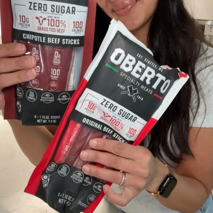 Creator holding Oberto zero sugar beef stick multipacks, framed as a youth sports mom-bag snack